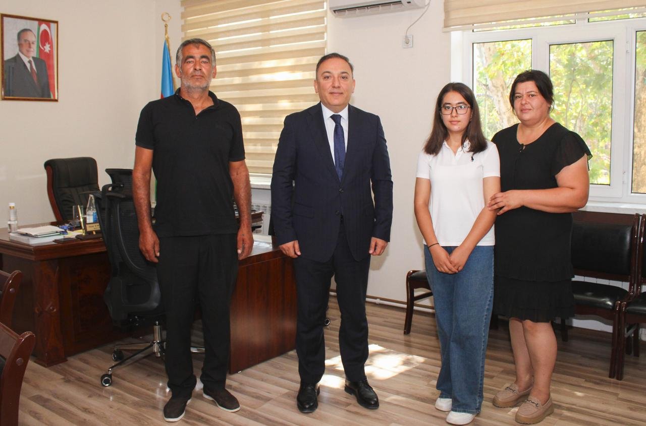 Mingachevir State University Rector Anar Eminov and student Aysu Ismayilova during the meeting