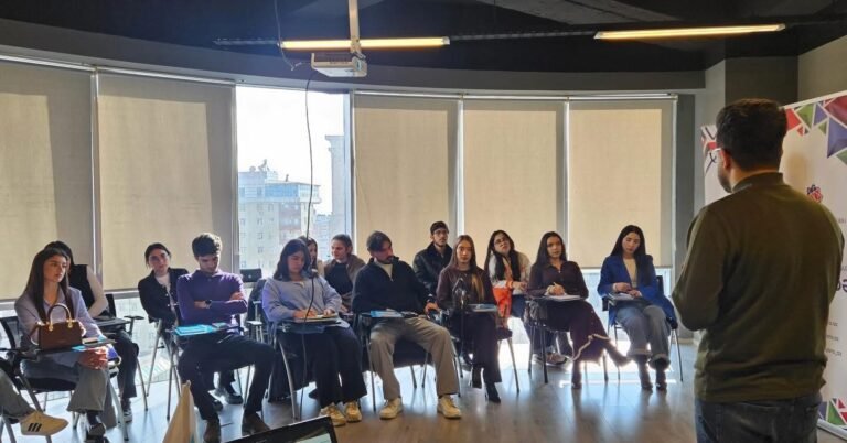 Young people taking part in a social project management training session