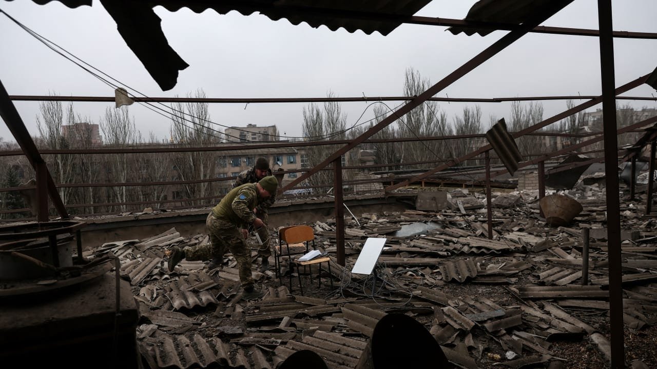 Starlink satellite communications equipment being removed from a damaged building roof in Kramatorsk, Ukraine